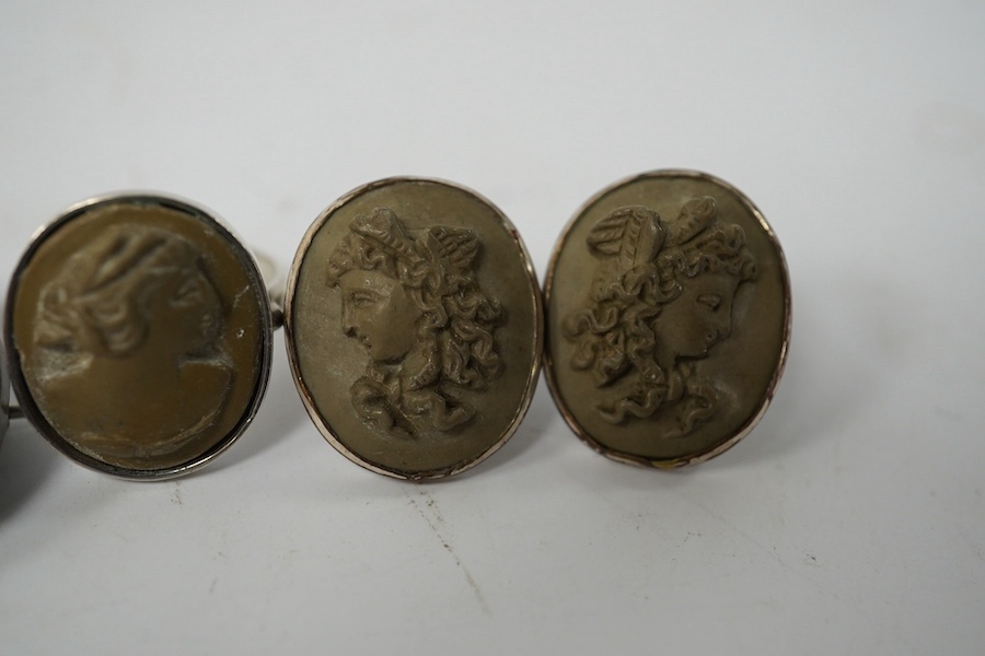 Three assorted carved cameo lava brooches, largest 32mm, together with a pair of similar earrings and a 930s and cameo lava ring. Condition - poor to fair